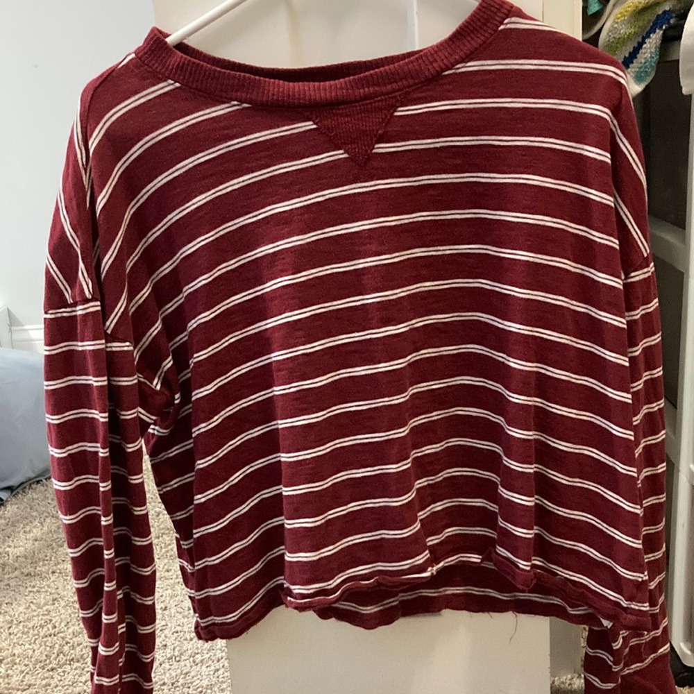 Red and white striped slightly cropped long sleeve shirt